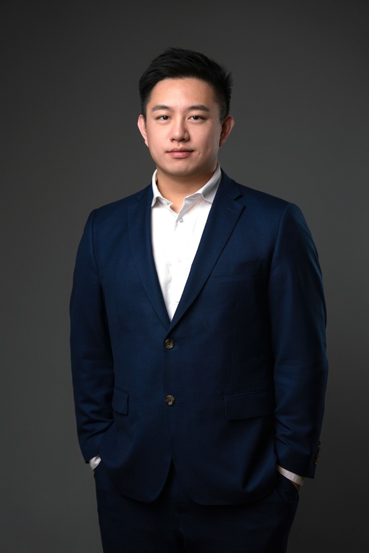 Kevin Hoang, licensed Massachusetts real estate broker, in a navy suit